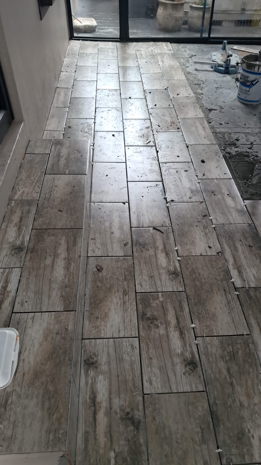 Wood-look floor tiling in progress